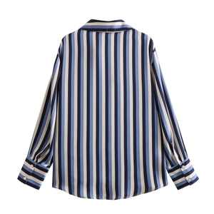 Detail view of the back of a blue and white striped satin shirt with long sleeves