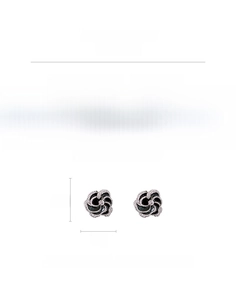 Macro view of black and white flower earrings with rhinestones and silver needle detail