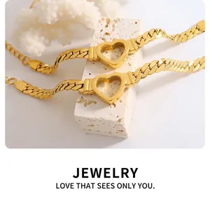 Detailed shot of two vintage gold heart pendants on thick Cuban chains over minimalist stones