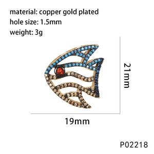 Detail of copper gold plated tropical fish pendant with colorful cubic zirconia