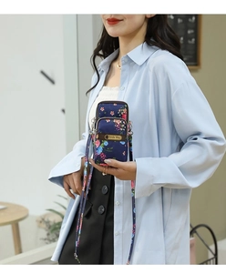Detail of floral nylon shoulder bag with adjustable strap and brand logo label