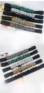 Detail view of five colors elastic waist belts decorated with sparkling crystals for dresses