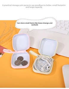 Macro view of pink and beige square tinplate coin purses storing earphones and coins