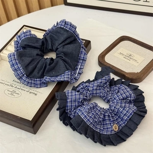 Blue denim and plaid pattern scrunchies set with retro wooden button on white background