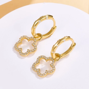 Macro shot of gold-plated hollow flower hoop earrings with micro-inlaid cubic zirconia