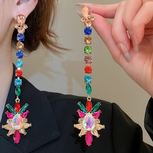 Detail of long drop earrings featuring colorful rhinestones in a floral cluster design