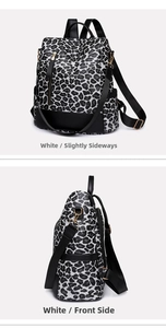 Detail view of stylish leopard print backpack with gold hardware and tassel accent