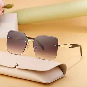 Women's oversized rimless fashion sunglasses with brown gradient lenses and gold metal arms