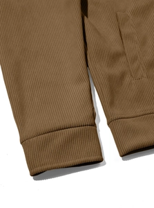 Detailed macro shot of brown corduroy shirt showing ribbed cuffs and stitched side pockets