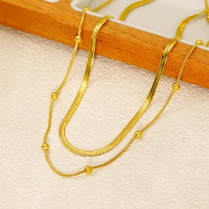 Double-layer gold stainless steel necklace featuring sleek snake and round bead chains