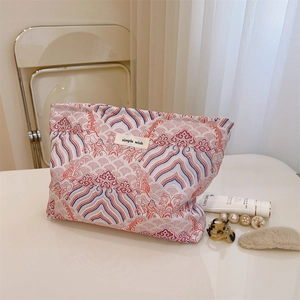 Detail of fabric makeup bag with oriental wave pattern and a Simple Wish label