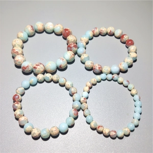 Detailed top view of natural jasper stone bracelets in various bead sizes and textures