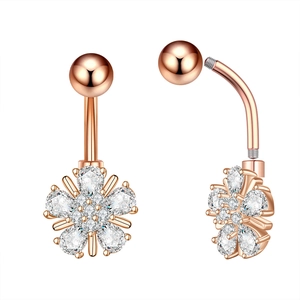 Macro view of rose gold navel ring featuring white zircon floral inlay and screw-in structure
