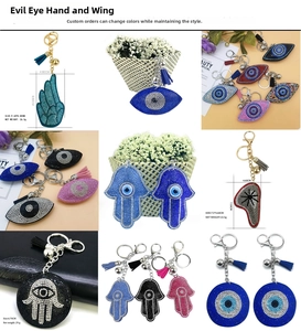 Detailed view of rhinestone evil eye and hamsa hand keychains with tassels and bells