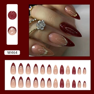 Detailed set of red and nude glitter press-on nails with golden French tip accents
