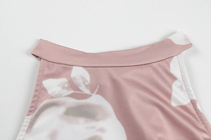 Close-up of floral print neckline with smooth stitching on a pink summer dress