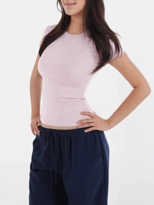 Close-up of pink slim fit ribbed knit T-shirt featuring a classic round neck design