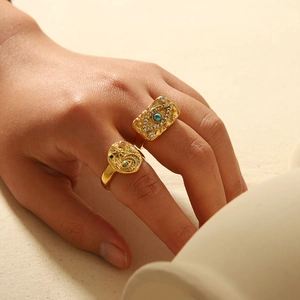 Retro 18K gold stainless steel evil eye and celestial rings set on model's hand