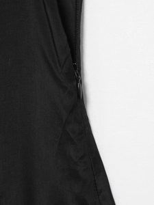 Macro shot of invisible back zipper and fine fabric texture on a black sleeveless dress
