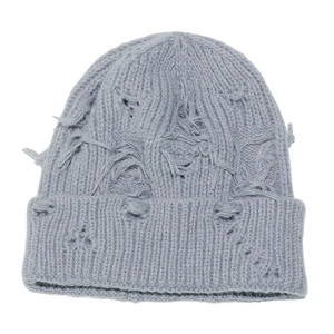 Detailed view of the distressed knit pattern and torn holes on this light blue beanie