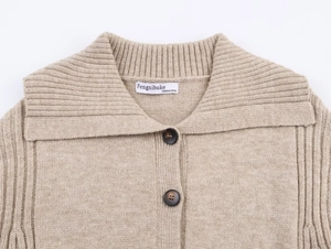 Detailed view of beige ribbed knit cardigan featuring large collar and wood-like buttons