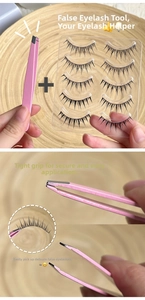 Precision pink lash tweezers picking up individual fiber eyelashes on a wood tray