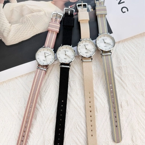 Minimalist quartz watches with colorful fabric straps in pink stripes, black, beige and grey