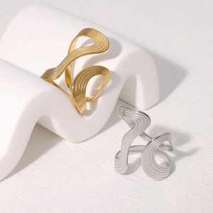 Minimalist stainless steel wave rings in gold and silver with brushed texture finish