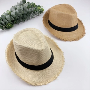 Detail of breathable straw hats with frayed edges and black grosgrain decorative bands