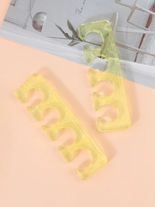 Macro detail of soft yellow glitter silicone toe separators for nail polish application