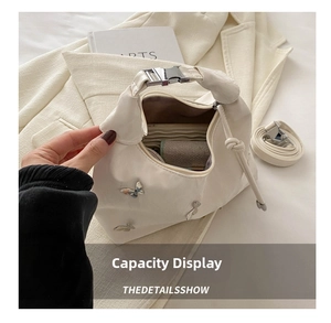 Top view of cream white tote bag with butterfly studs showing spacious inner storage