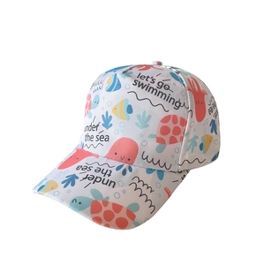 Detail of kids baseball cap featuring colorful ocean animal prints and swimming text