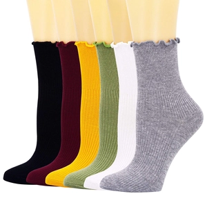 Six pairs of colorful ribbed knit socks for women with elegant lettuce trim in a studio shot