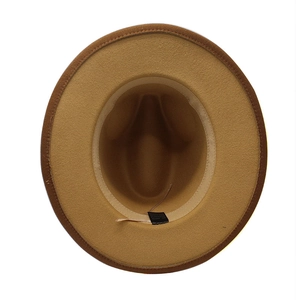 Detail view of the interior sweatband and material label of the beige wide brim fedora