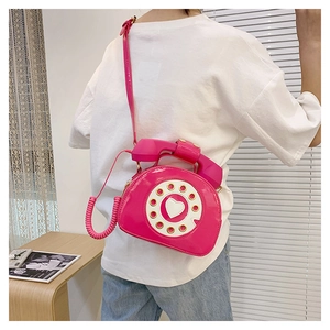 Creative pink telephone cross-body bag with retro handset handle and Y2K aesthetic