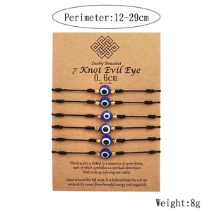 Set of 6 adjustable evil eye woven friendship bracelets with blue resin beads on card