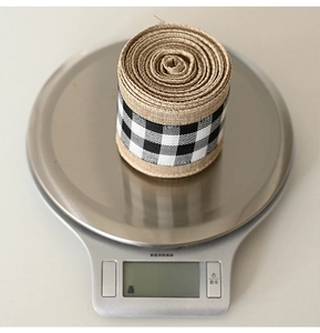 Linen decorative ribbon with black and white plaid pattern on digital scale weighing 69.0g
