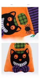 Detail view of Halloween drawstring bag with cartoon cat patch and plush orange fabric