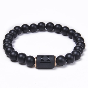 Macro view of matte black onyx Libra bracelet with rose gold plated metal spacers