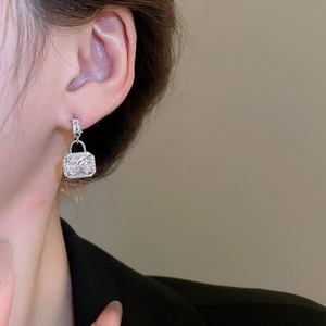 Close-up of square zircon drop earrings on model showcasing silver finish and sparkle