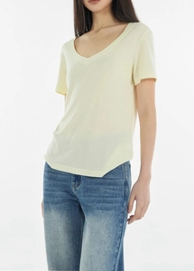 Detail of the soft V-neckline and breathable wool-blend fabric on this yellow T-shirt