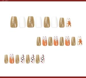 Close-up of Christmas press-on nails with gingerbread man and glitter patterns