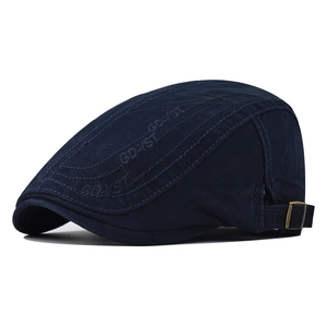 Detail of dark blue cotton beret with GD-YST embroidery and bronze adjustable metal buckle