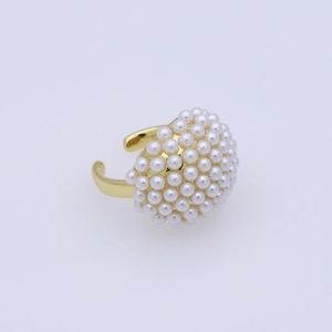 Close-up of adjustable gold open ring featuring elegant white round pearls on the band