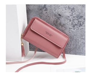 Detailed close-up of pink leather phone bag featuring fringe tassel and gold zipper