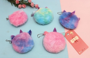 Macro detail of plush unicorn coin purse with colorful faux fur and sequined ears