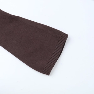 Detail of dark brown knit sleeves showing ribbed cuffs and high-quality stitch texture