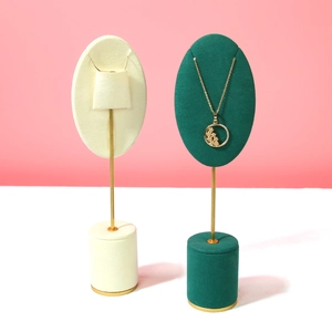 Elegant metal jewelry display stand with velvet oval base for necklaces and pendants