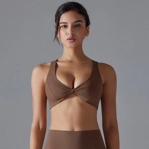 Detailed view of the twist-front cutout and wide straps on this mocha yoga sports bra