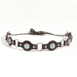 Detail of brown leather belt with turquoise stones, silver rings and rivet accents